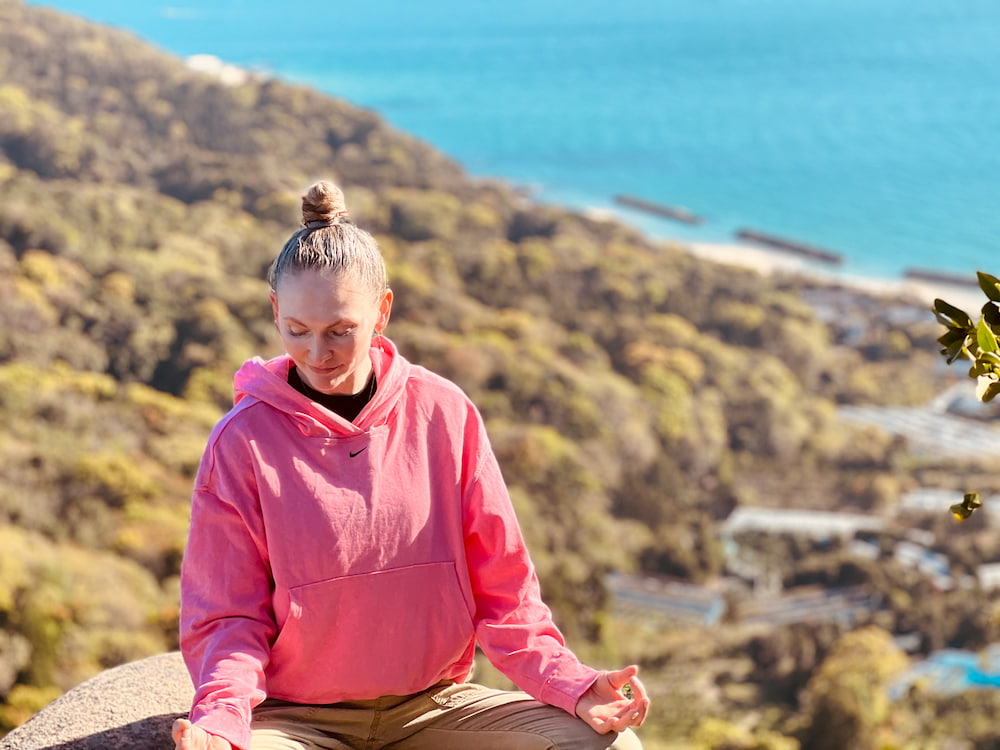 Relaxing and refreshing at the mountain top with eyes closed